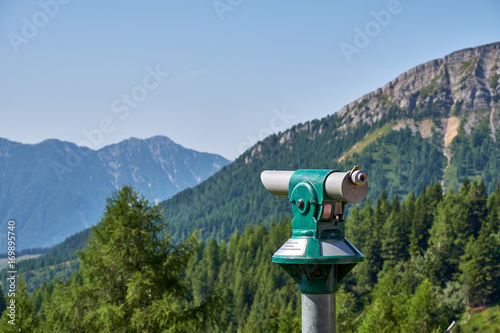 Free tourist telescope standing on the top of the Panoramastrasse on Mt. Goldeck the soft Staff peak in the background photo