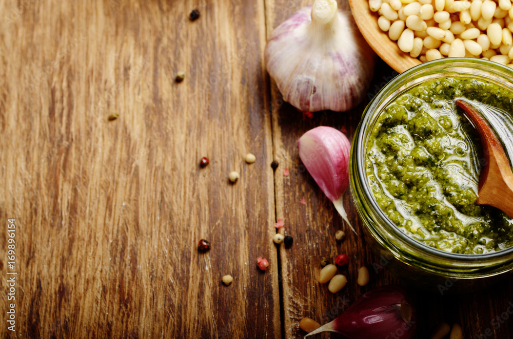 Top view of Pesto sauce and ingredients on wood table with copy-space Top view of Pesto sauce and ingredients on wood table with copy-space