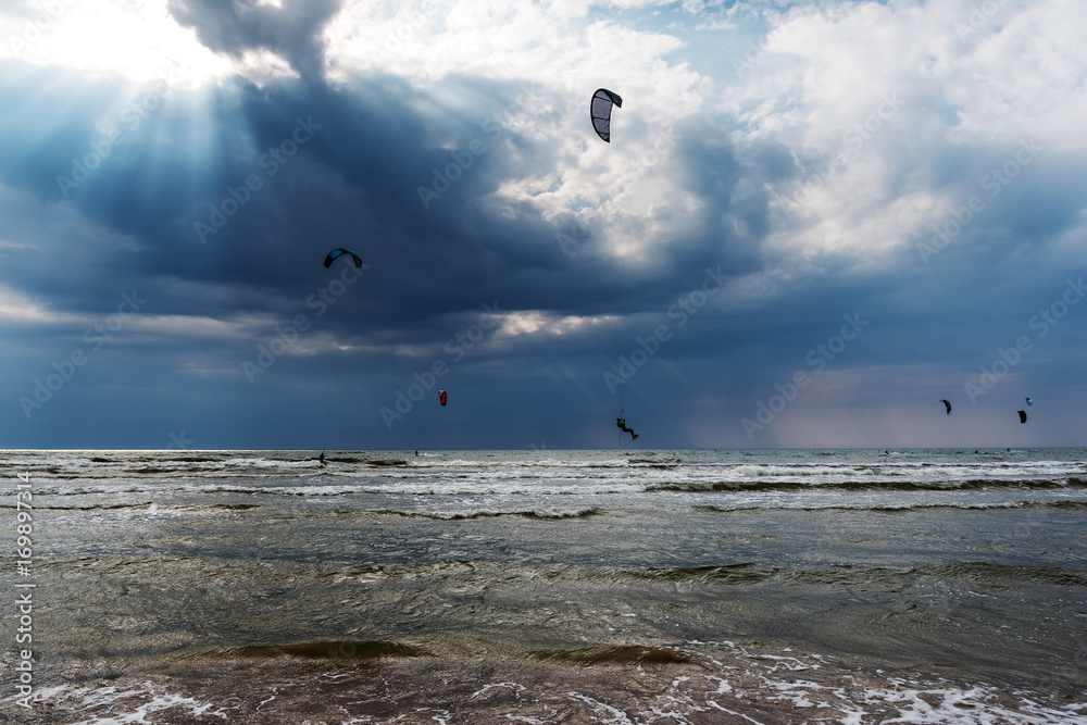 Kite surfers and dark Baltic sea.