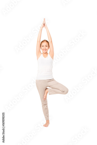 Pretty slim smile woman fitness Yoga exercises .A asian girl  practicing yoga as a form of relaxation ,studio full length shot , isolated on white