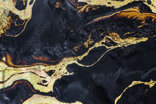 Valokuva Oil spill texture on the sand beach