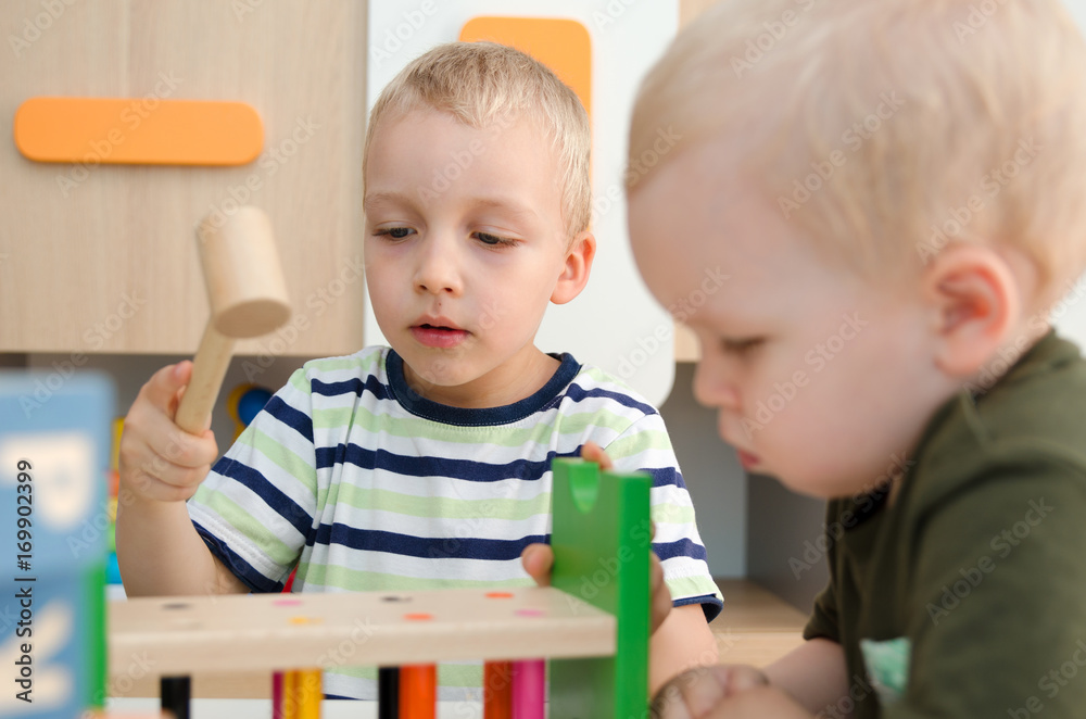 Kids boys playing with toy blocks at home or kindergarten Kids boys playing with toy blocks at home or kindergarten