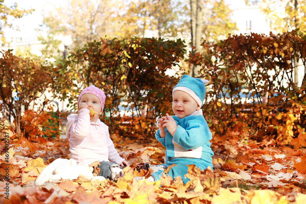 Two Little child in nature sitting in open suitcase. Two Little child in nature sitting in open suitcase.
