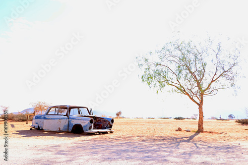 Rusty old car corroding in the desert in namibia