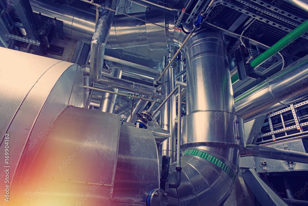 Equipment, cables and piping as found inside of a modern industrial power plant Equipment, cables and piping as found inside of a modern industrial power plant