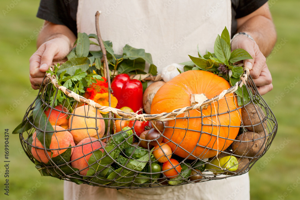 Man holding a basket full of vegetables
