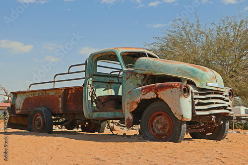 Rusty old car corroding in the desert in namibia