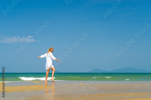 woman walking to the water on the beach