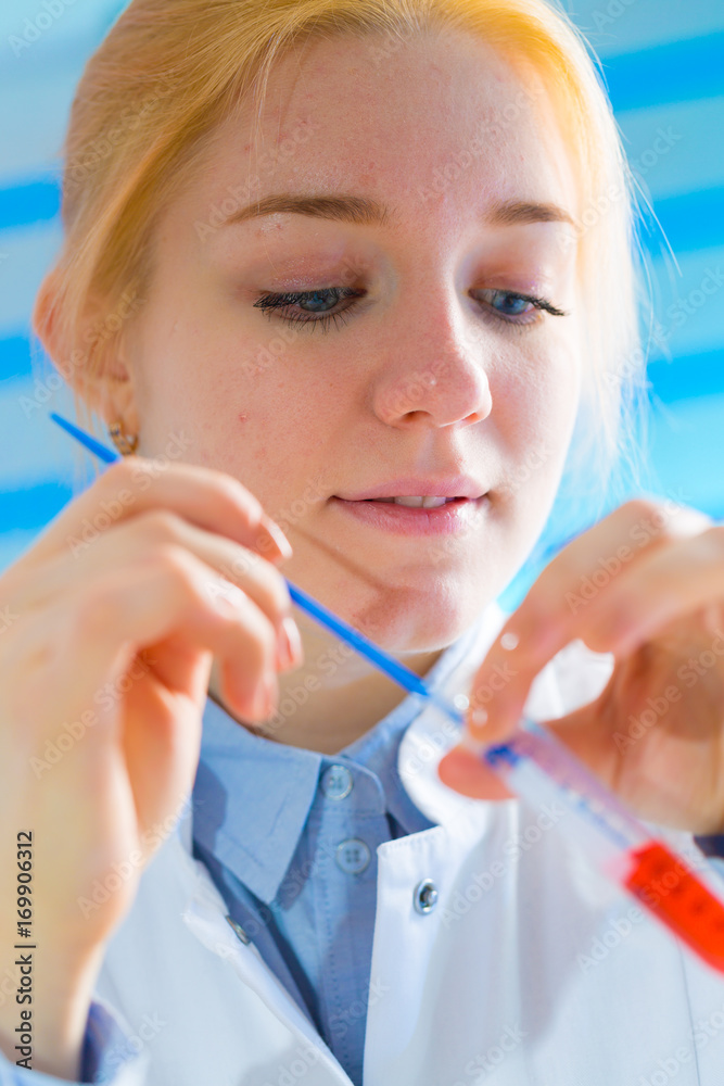 Laboratory assistant in the medical laboratory control a microbiological analysis of the blood. Using a pipette and a test tube in the laboratory Laboratory assistant in the medical laboratory control a microbiological analysis of the blood. Using a pipette and a test tube in the laboratory