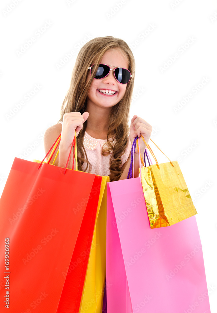Adorable little girl child in sunglasses holding shopping colorful paper bags Adorable little girl child in sunglasses holding shopping colorful paper bags