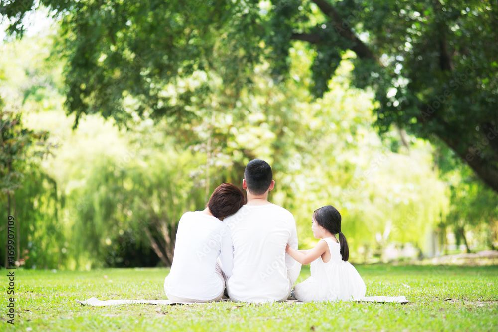 Young happy Asian family spending time together at the park. Young happy Asian family spending time together at the park.