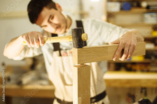 Construction Worker Building Timber Frame In New Home photo