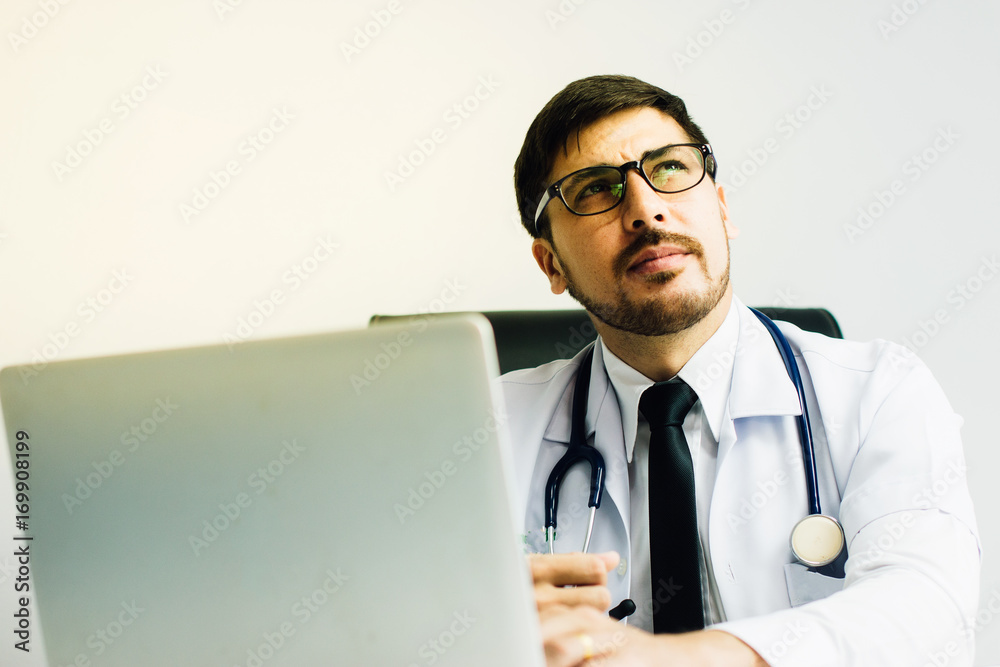 Doctor in a lab coat holding a stethoscope for patient examination. Doctor in a lab coat holding a stethoscope for patient examination.