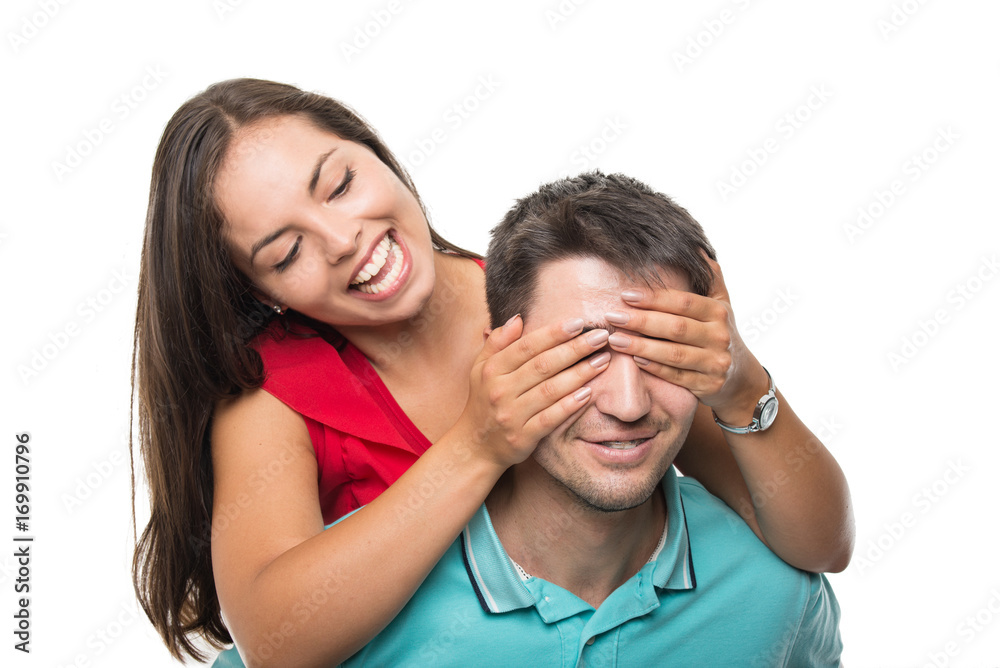 Close-up happy young couple being playful covering eyes Close-up happy young couple being playful covering eyes