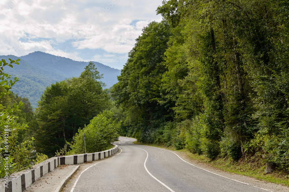 Fototapeta premium Curved asphalt road in mountains