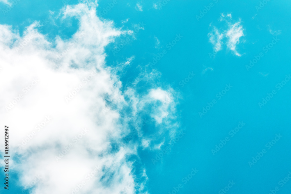 Teal blue sky with white clouds and copyspace Teal blue sky with white clouds and copyspace