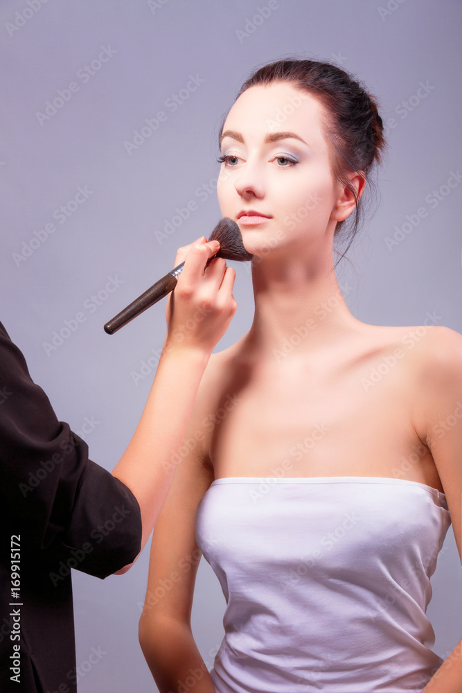 Female / woman / girl preparing for show. Makeup artist with makeup brush for eye doing professional makeup for young woman. Backstage Female / woman / girl preparing for show. Makeup artist with makeup brush for eye doing professional makeup for young woman. Backstage