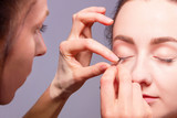 Female / woman / girl preparing for show. Makeup artist increase eyelashes for fashion model. Backstage