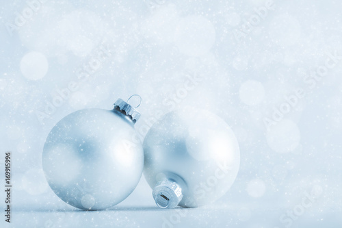 Christmas glass balls on cold frosty glitter background
