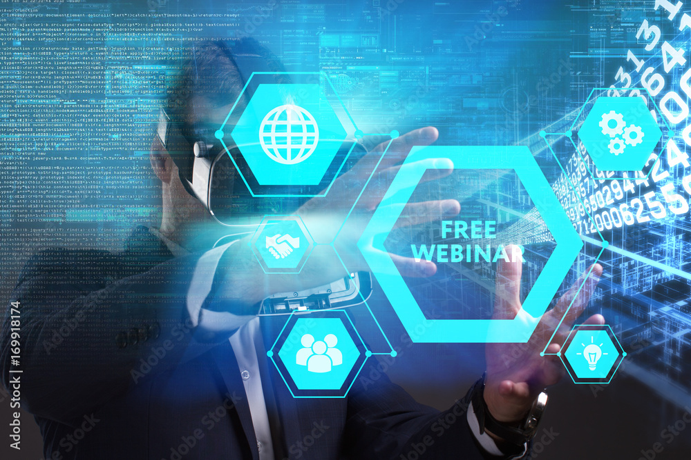 Business, Technology, Internet and network concept. Young businessman working in virtual reality glasses sees the inscription: Free webinar Business, Technology, Internet and network concept. Young businessman working in virtual reality glasses sees the inscription: Free webinar