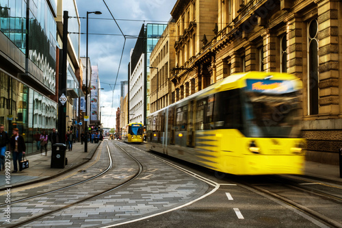 Light rail yellow tram in the city center of Manchester, UK photo
