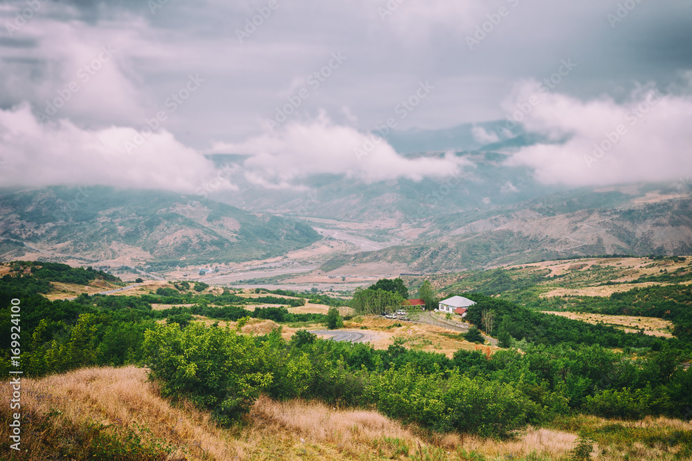 View of mountains Babadag in the clouds and a river Girdimanchay Lahij yolu from the side in Lahic village, Azerbaijan