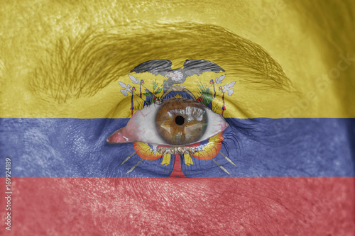 Human face and eye painted with flag of Ecuador