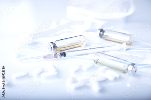 Pills  capsules  syringe and ampoules on  fabric background. Medical background.