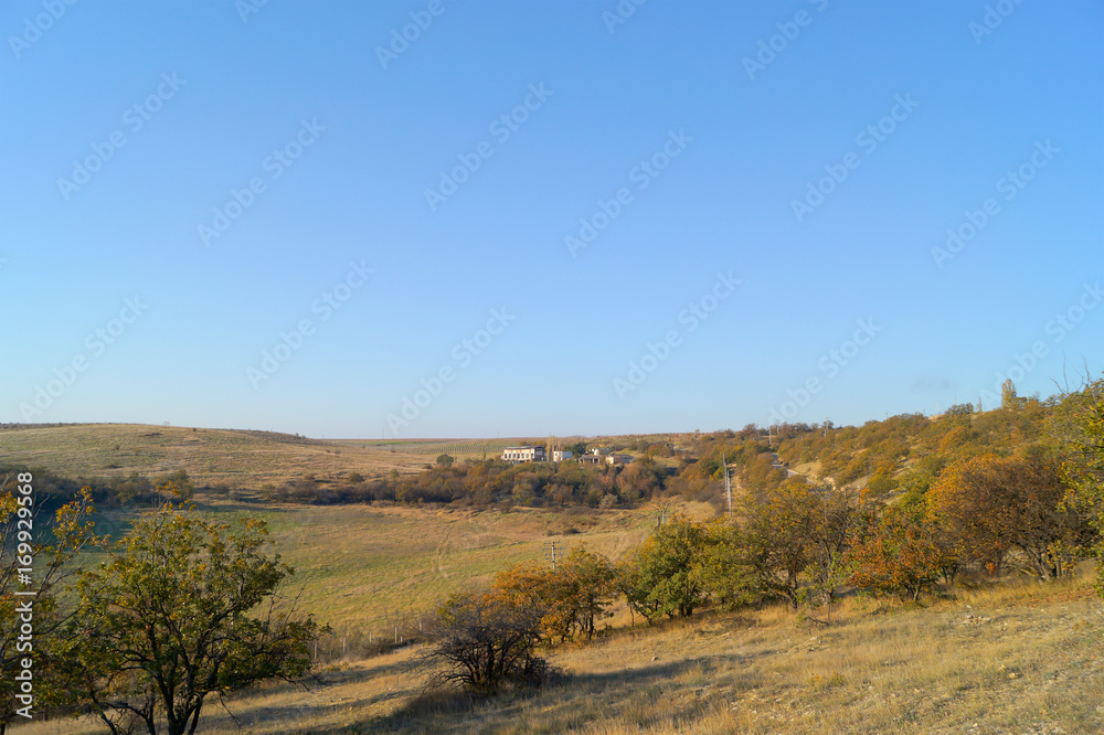 Autumn landscape with hills, trees and clean blue sky Autumn landscape with hills, trees and clean blue sky