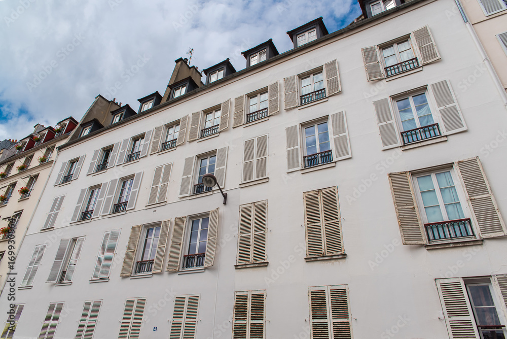     Paris, attractive facades in Saint-Germain-des-Pres, with geometry of the windows, charming typical building 
