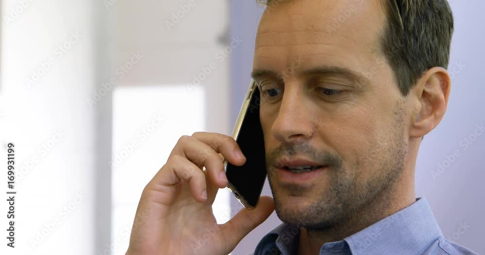 Male executive talking on mobile phone Male executive talking on mobile phone