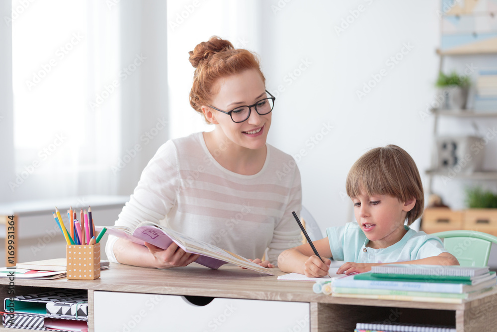 Smiling mother helping son Smiling mother helping son