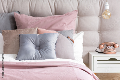 Bed with pastel color pillows