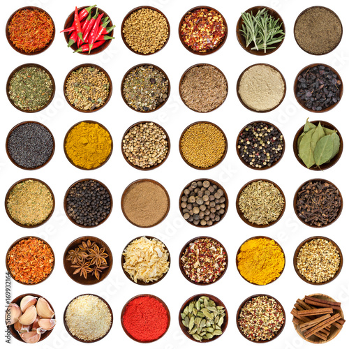 Set of different spices in wooden bowl. Top view.