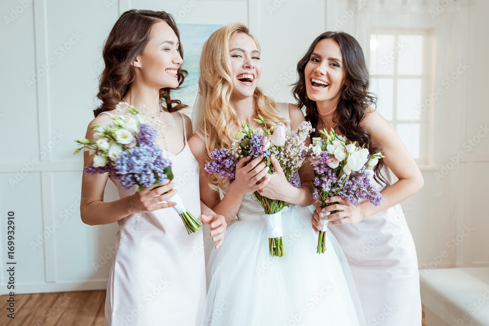 laughing bride with bridesmaids - obrazy, fototapety, plakaty 