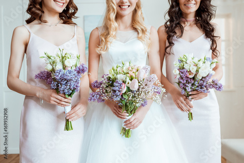 bride with bridesmaids holding bouquets photo