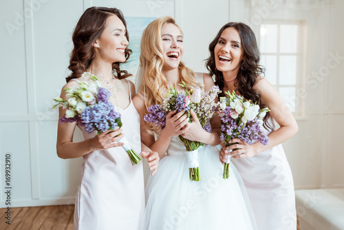 laughing bride with bridesmaids
