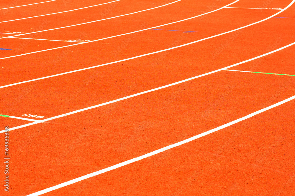 Fototapeta premium red running track on athletic stadium