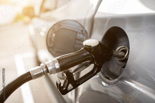 pumping gasoline fuel in car at gas station