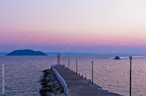 Pier at twilight with turtle island in a background  near the city of Neos Marmaros in Sithonia  Greece