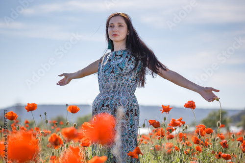 Fototapeta Naklejka Na Ścianę i Meble -  Woman in patterned sundress on flower field
