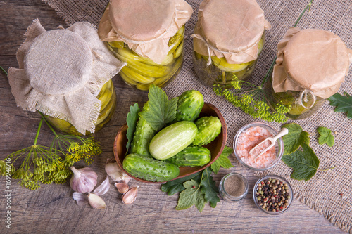 Salted cucumbers. Spices and herbs for making pickles on wooden background