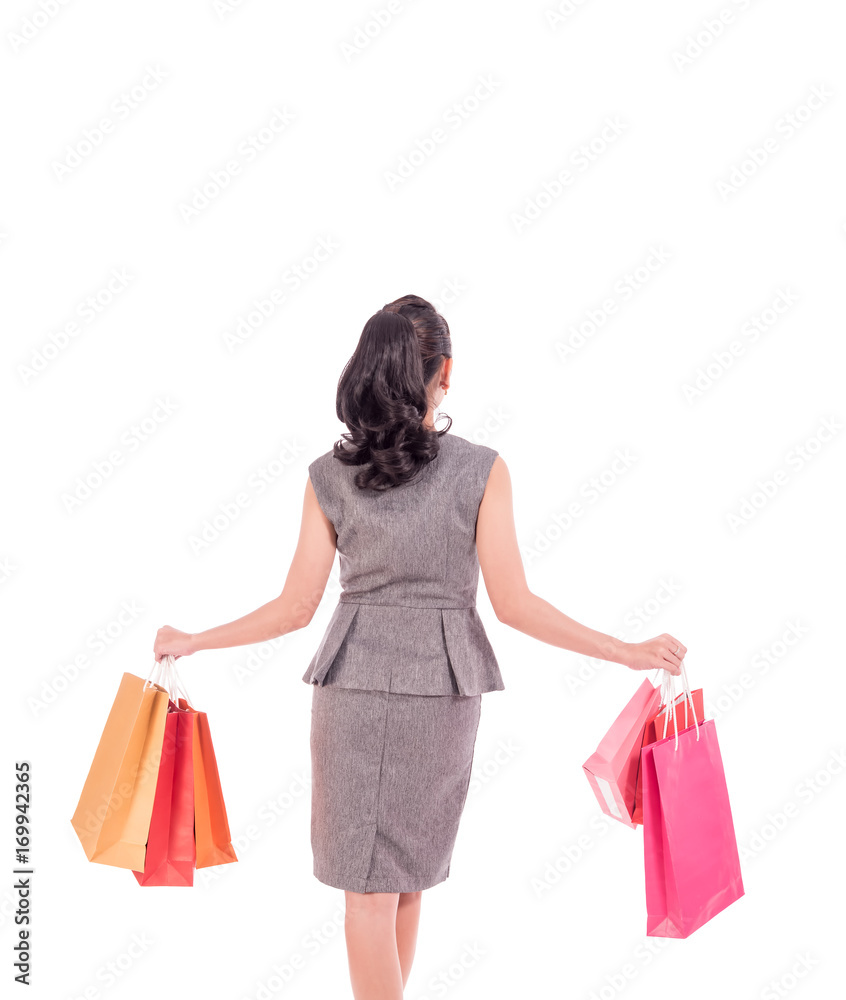 Cheerful shopping woman of Asian holding bags. Shopping smart business woman happy smiling holding colorful shopping bags isolated on white . Fresh young Asian female model, back side of body