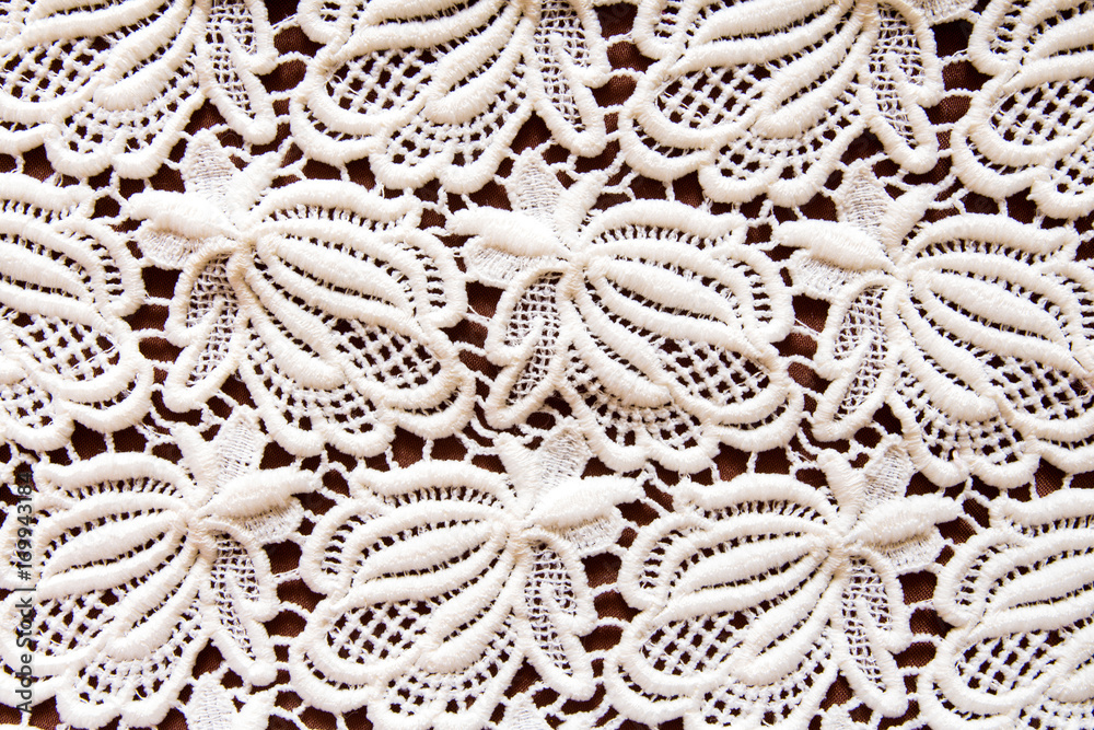 Old napkin embroidery of white thread handmade on a dark background in vintage retro antique style Old napkin embroidery of white thread handmade on a dark background in vintage retro antique style