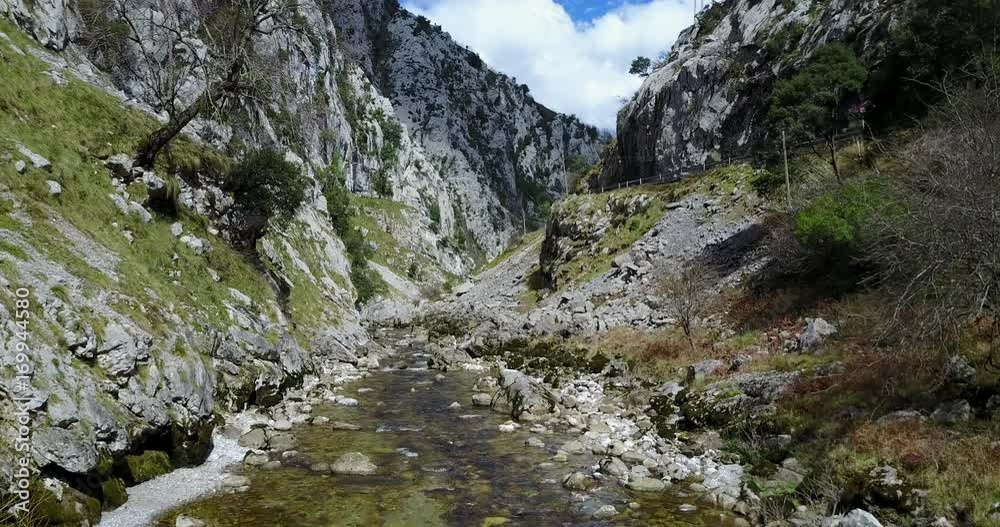 Flying through a gorge above a river at Picos de Europa Flying through a gorge above a river at Picos de Europa