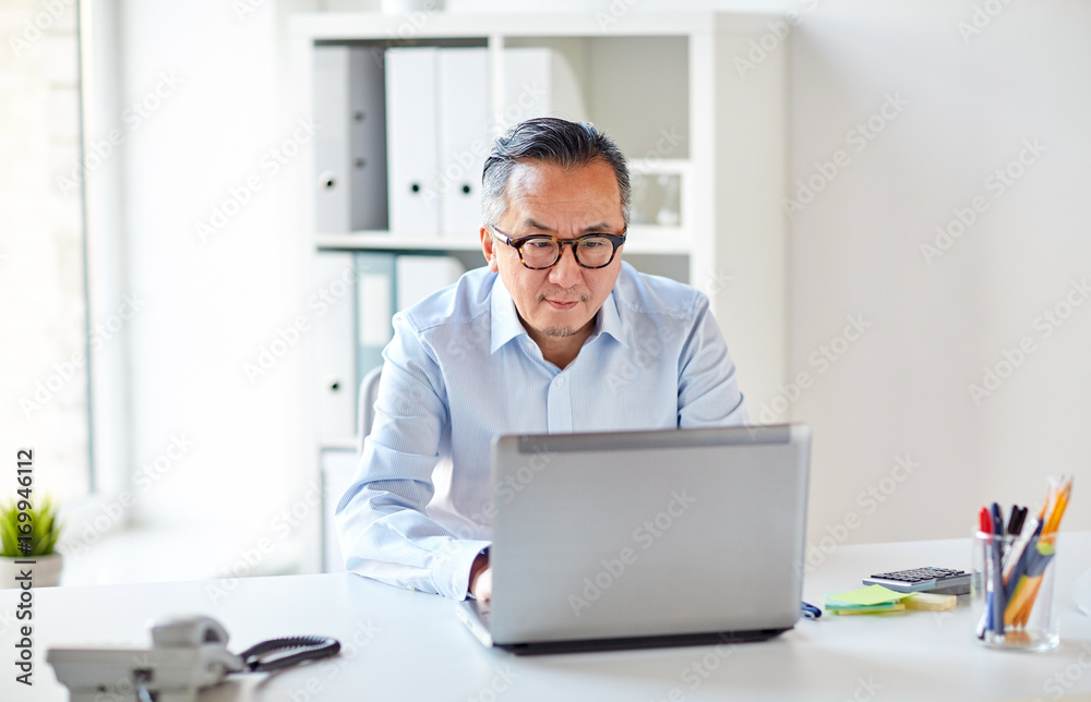 businessman in eyeglasses with laptop office