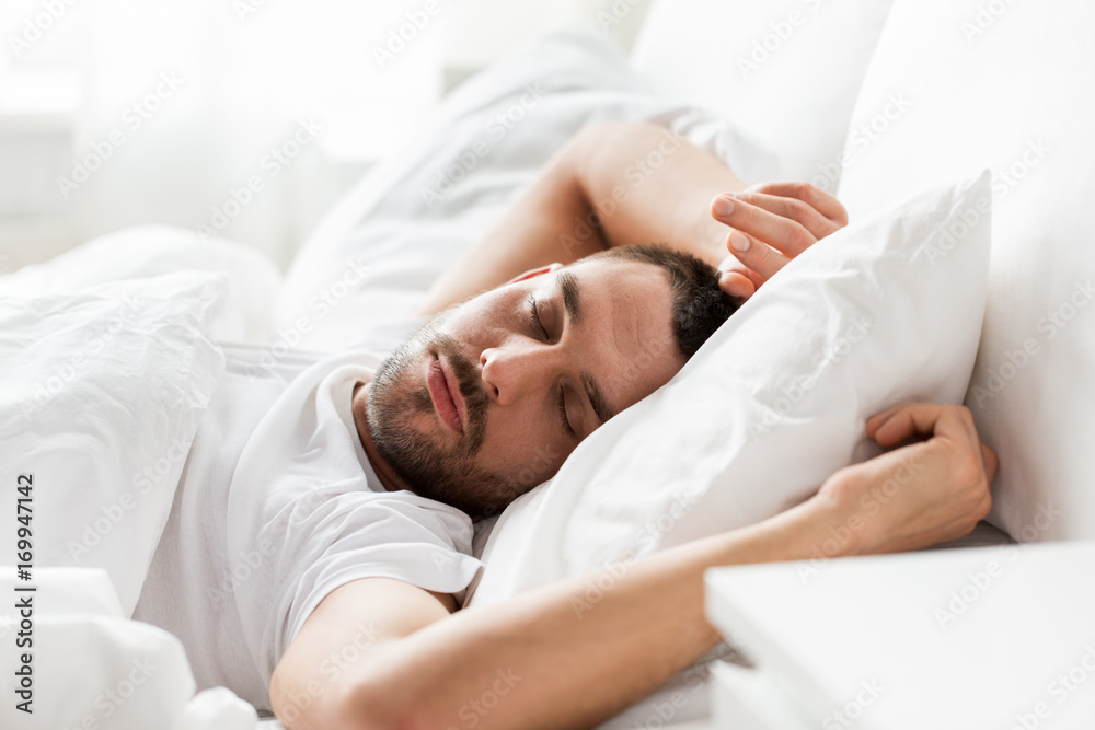 man sleeping in bed at home - obrazy, fototapety, plakaty 
