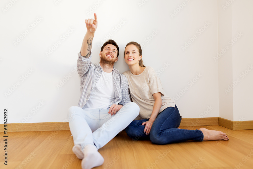 happy couple at empty room of new home happy couple at empty room of new home