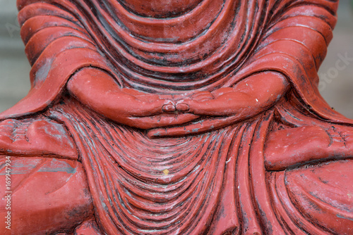hand of a sitting Buddha statue in a public Buddhist temple in Bangkok, Thailand