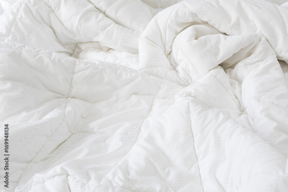 Close up messy white sheet and pillows on bed bedroom interior Close up messy white sheet and pillows on bed bedroom interior